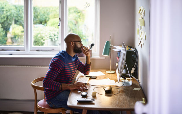 man sitting at desk working from home, Cybersecurity for Employees Working from Home