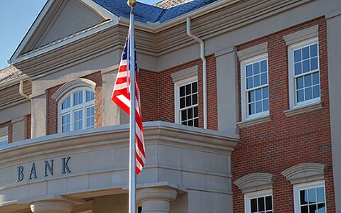 Front of bank with American flag