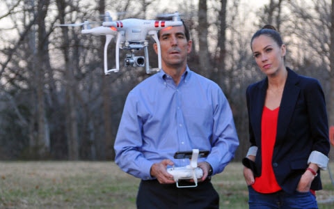 Stephanie Duchaine and home inspector Brian O'Rear flying drone
